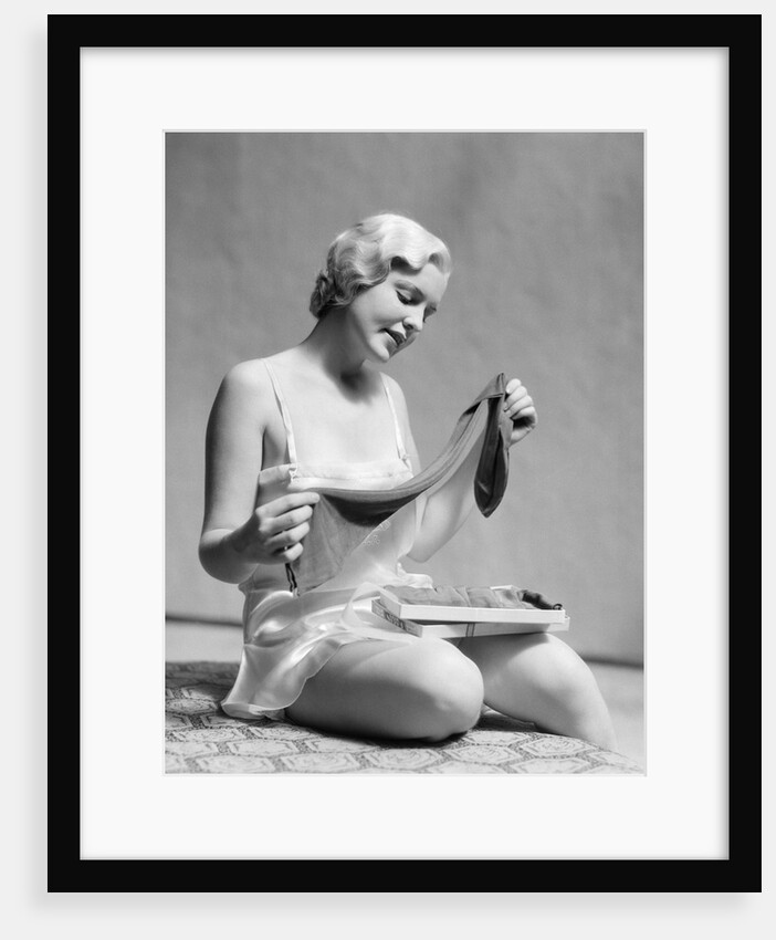 1930s Woman In Silk Teddy Lingerie Opening A Box Of Hosiery by Anonymous