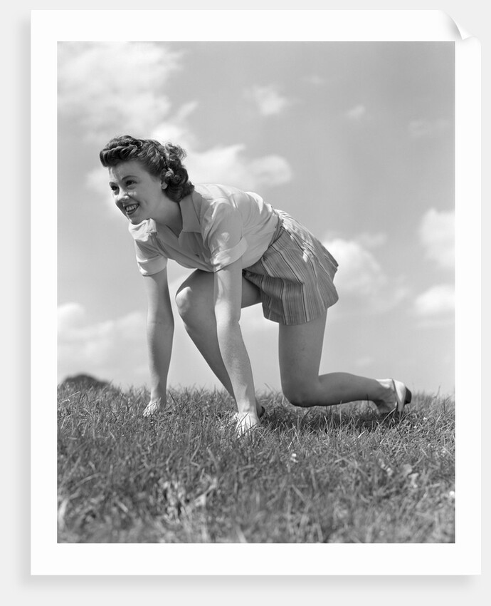 1940s Young Teen Woman Kneeling In Grass In Track Race Ready Starting Position by Anonymous