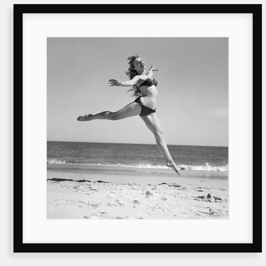1950s Woman In Bikini Running And Jumping On The Beach Smiling by Anonymous