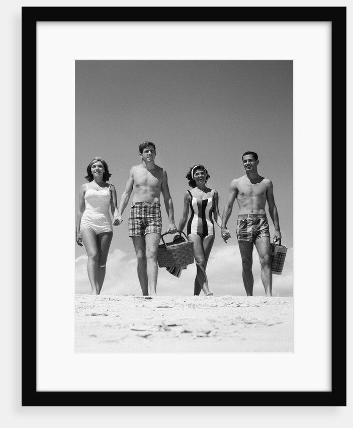 1960s Teenage Couples Wearing Bathing Suits On Beach Carrying Picnic Baskets by Anonymous