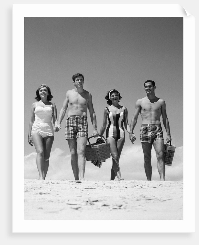 1960s Teenage Couples Wearing Bathing Suits On Beach Carrying Picnic Baskets by Anonymous