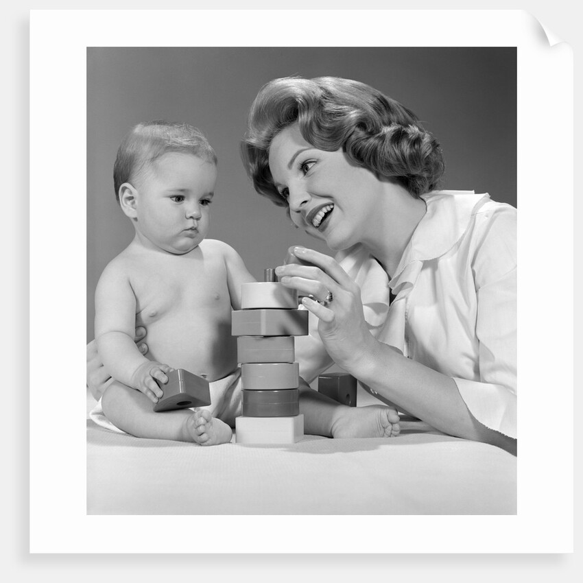 1960s Mother And Unhappy Baby Playing With Blocks by Anonymous
