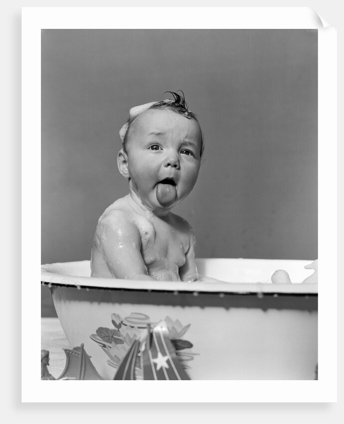1940s Wet Baby In Bath Covered With Soap Suds Sticking Out Tongue by Anonymous