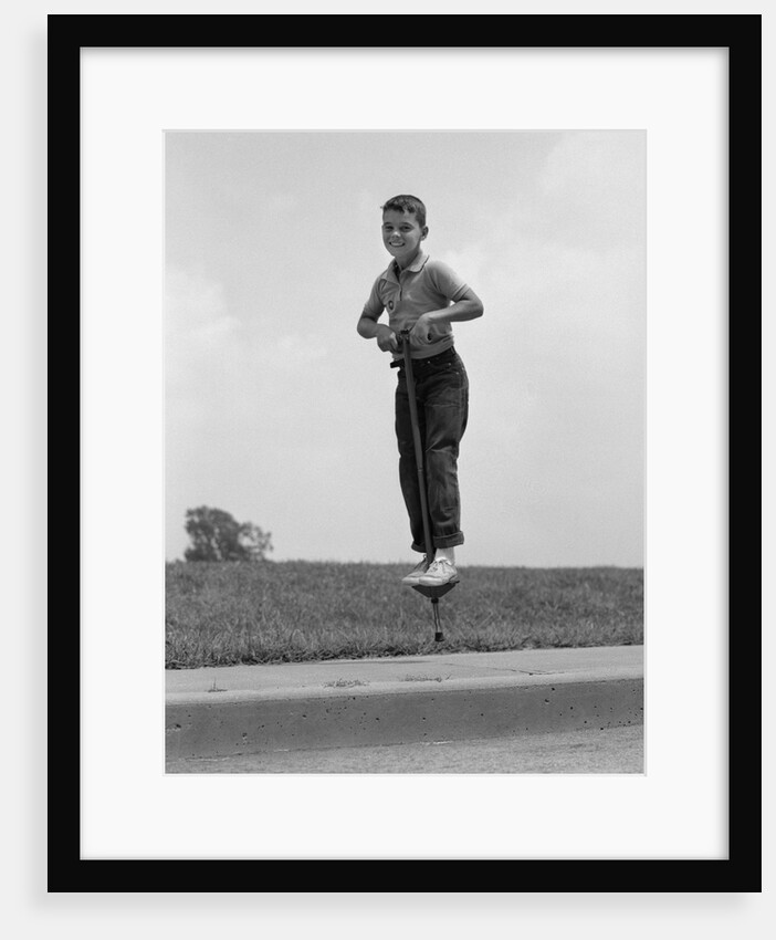 1960s Boy Jumping On Pogo Stick by Anonymous