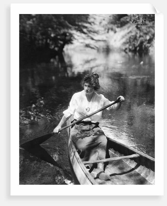1920s Woman With Upswept Hair Paddling Wooden Canoe In Stream by Anonymous