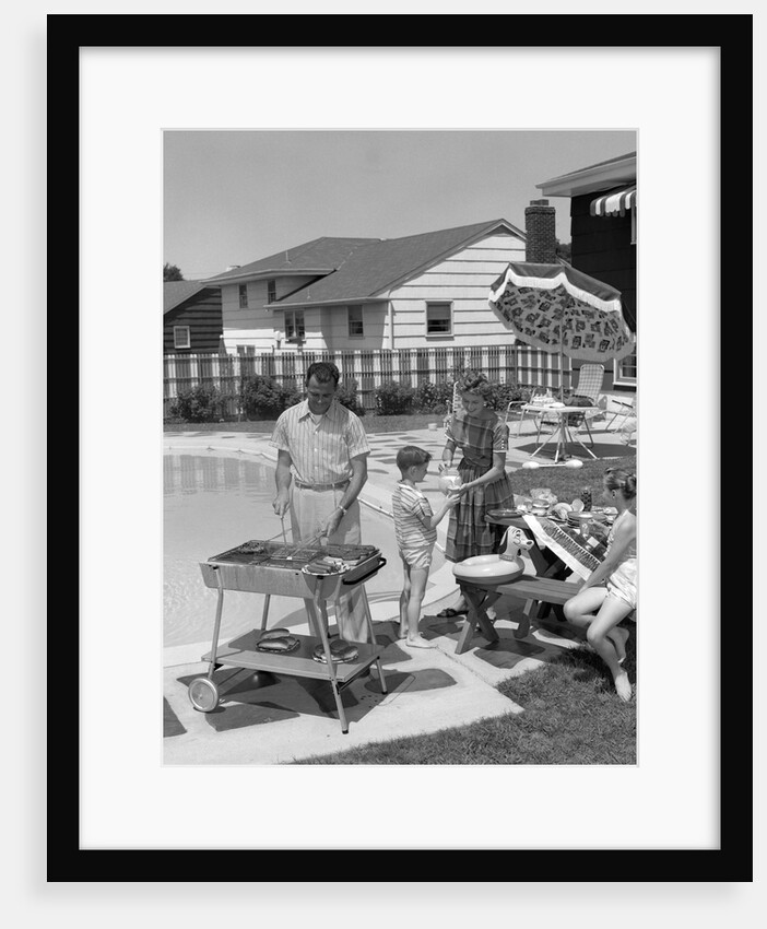 1950s Family In Backyard Beside Pool Having Cookout Of Hot Dogs and Hamburgers by Anonymous