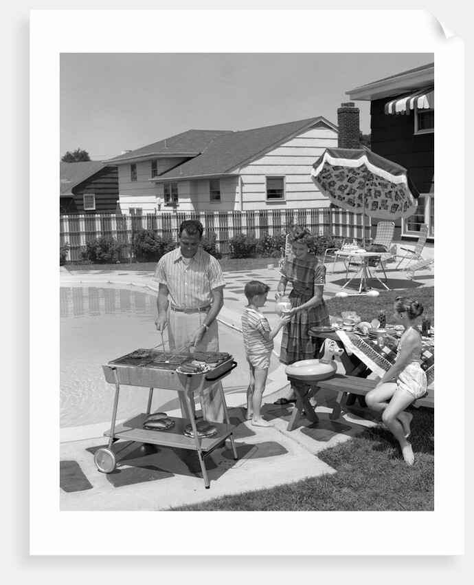 1950s Family In Backyard Beside Pool Having Cookout Of Hot Dogs and Hamburgers by Anonymous