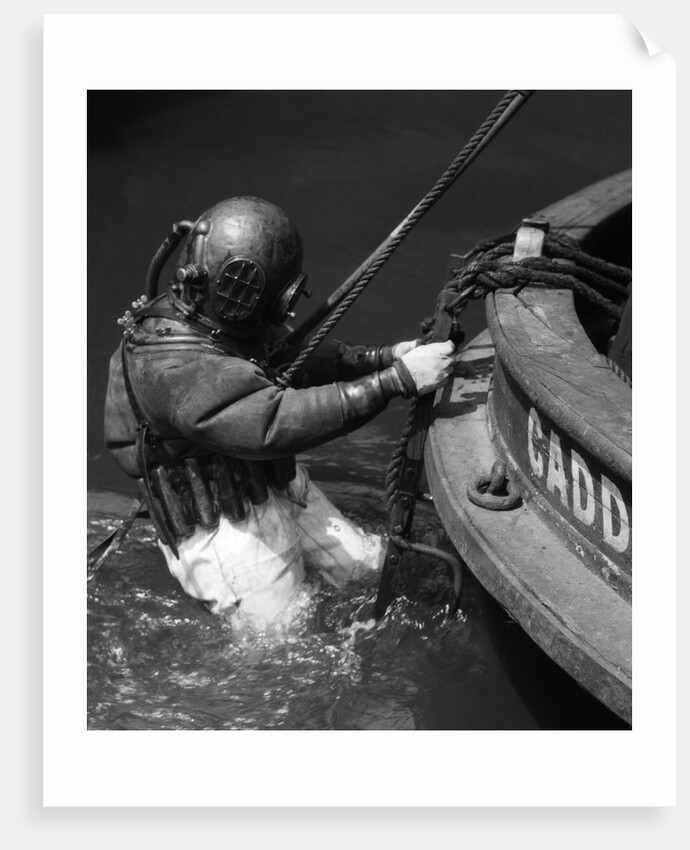 1930s Side View Of Diver In Pressure Suit Descending Into Water From Side Of Boat by Anonymous
