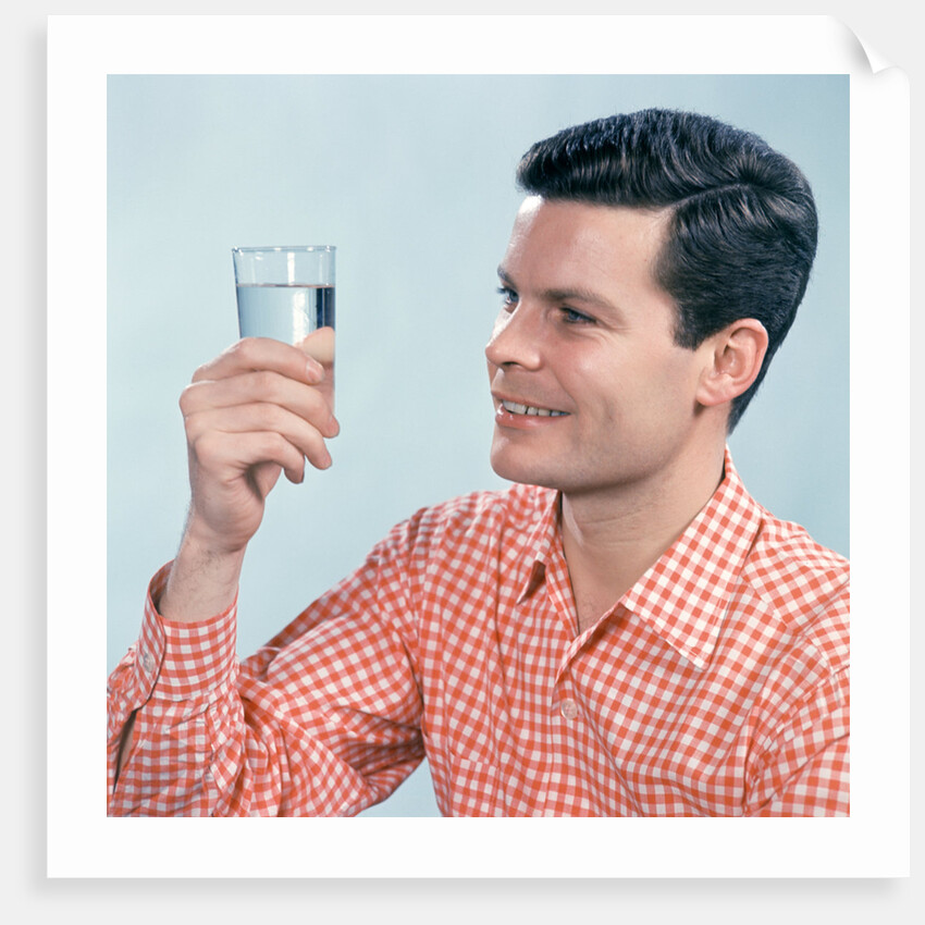 1960s Profile Man Wearing Red Checkered Shirt Holding Glass Of Water by Anonymous