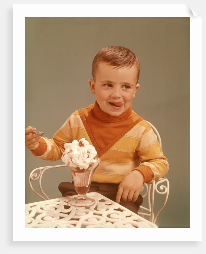 Boy Sitting At Ice Cream Parlor Table Eating Whipped Cream Cherry Topped Sundae+ by Anonymous