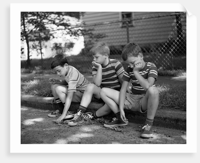 1970s Three Bored Boys Sitting On Curb All Wearing Striped Tee Shirts Shorts And Sneakers by Anonymous