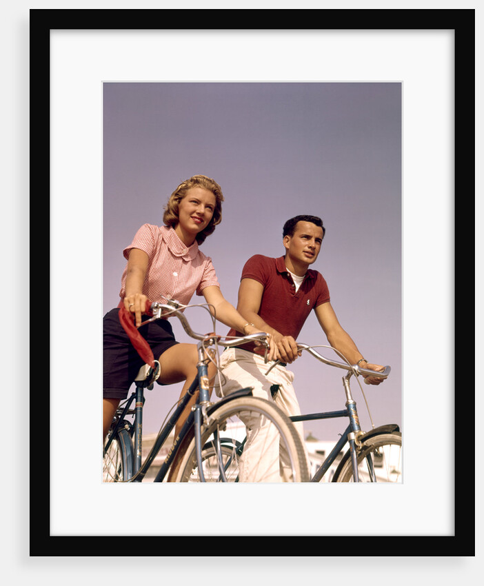 1950s 1960s Couple Man Woman Riding Bicycles Outdoors by Anonymous
