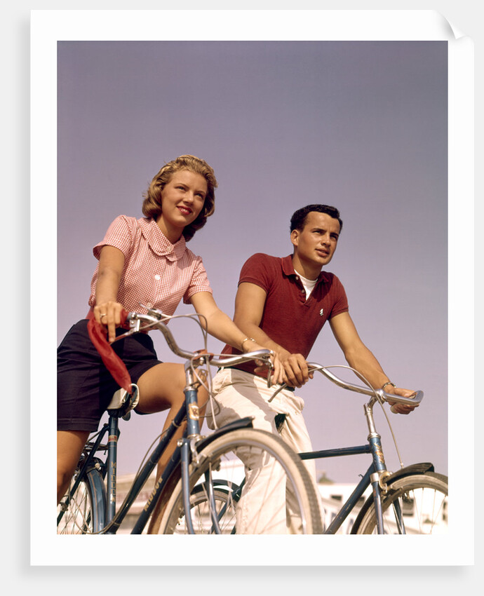 1950s 1960s Couple Man Woman Riding Bicycles Outdoors by Anonymous