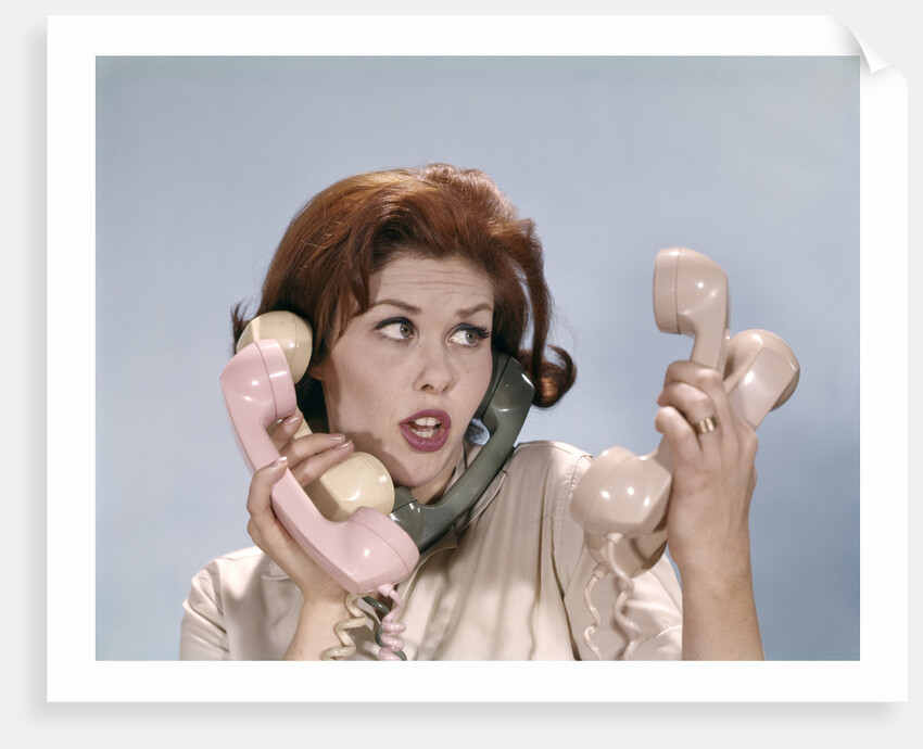 1960s Frustrated Young Redheaded Woman Trying To Answer Handle Five Telephone Receivers Studio by Anonymous