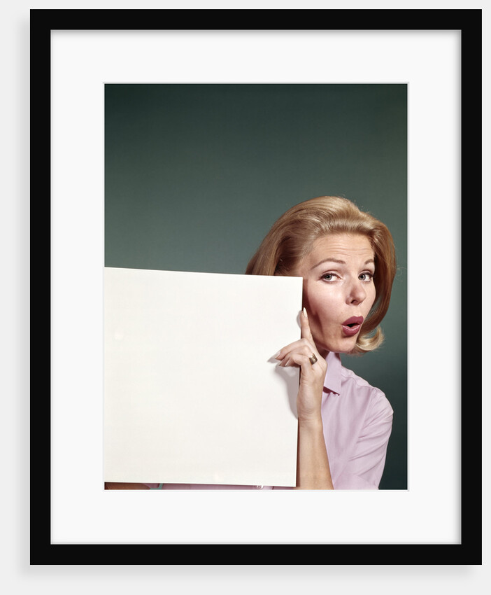 1960s Portrait Of Surprised Woman Peeking Around Sign Board by Anonymous