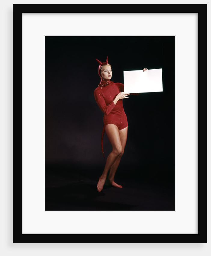 1960s Young Woman In Red Devil Costume Holding Sign Board In Hands by Anonymous