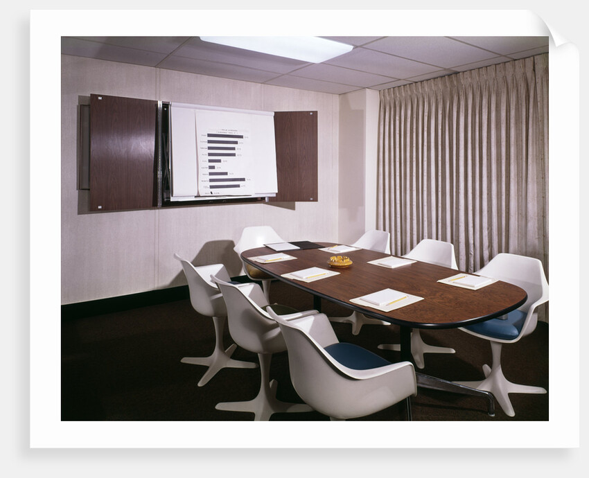 1960s Office Conference Room With Table Chairs Writing Pads Ashtray And Wall Chart by Anonymous
