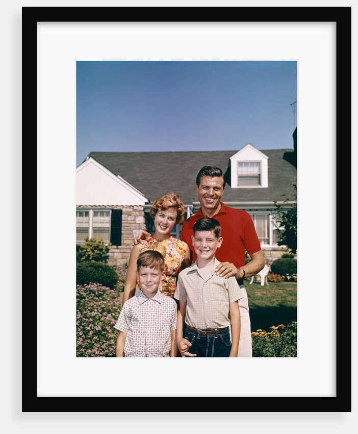 1960s Portrait Family Father Mother Two Sons Standing Together In Front Of Suburban House by Anonymous