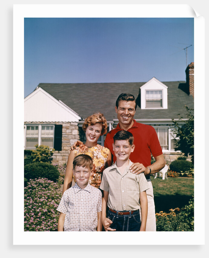 1960s Portrait Family Father Mother Two Sons Standing Together In Front Of Suburban House by Anonymous