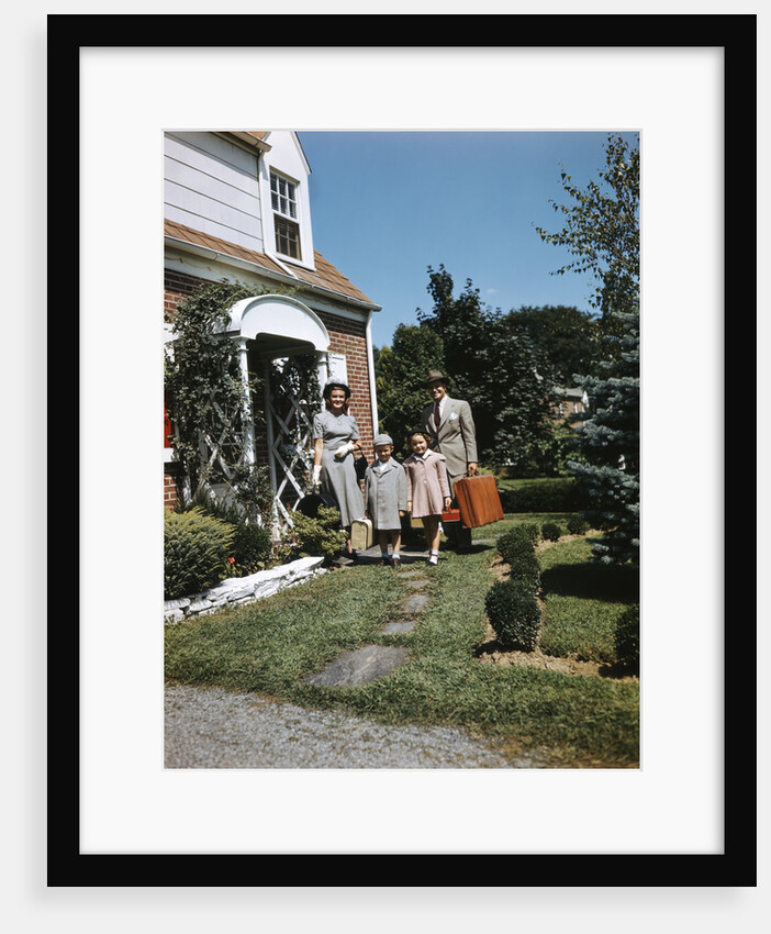 1940s 1950s Family Father Mother Daughter Son Leaving Suburban House Carrying Luggage by Anonymous