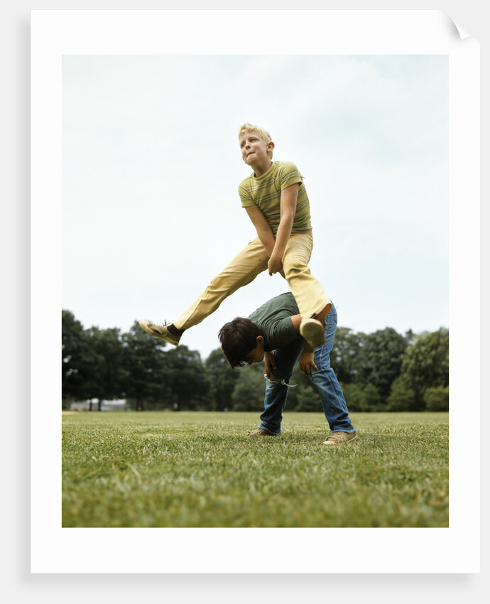 1970s Two Boys Jumping Playing Leapfrog by Corbis