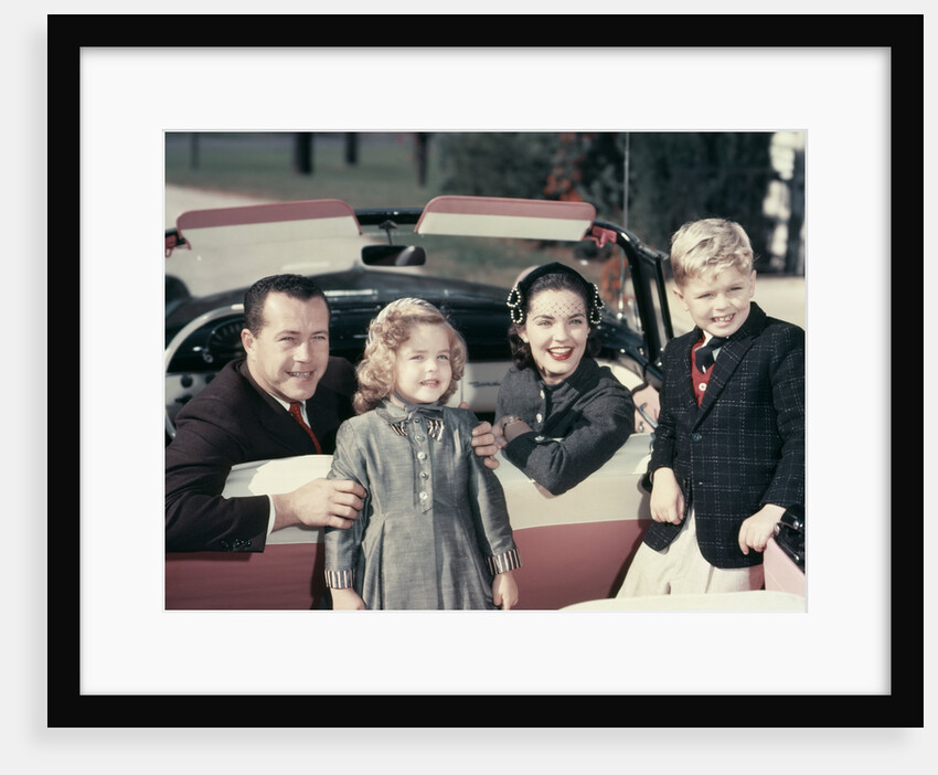 1950s Portrait Family Father Mother Son Daughter Sitting In Red White Convertible Automobile by Anonymous