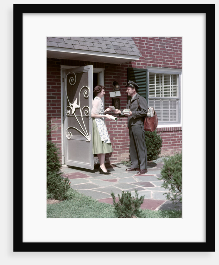 1950s Mailman Delivering Mail To Woman Brick Suburban Home by Anonymous