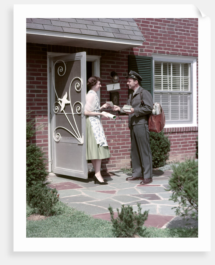 1950s Mailman Delivering Mail To Woman Brick Suburban Home by Anonymous