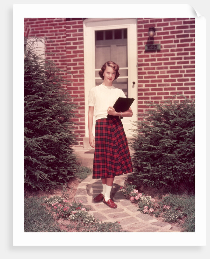 1950s Teenage Girl Holding School Books Walking Down Flagstone Walk by Anonymous