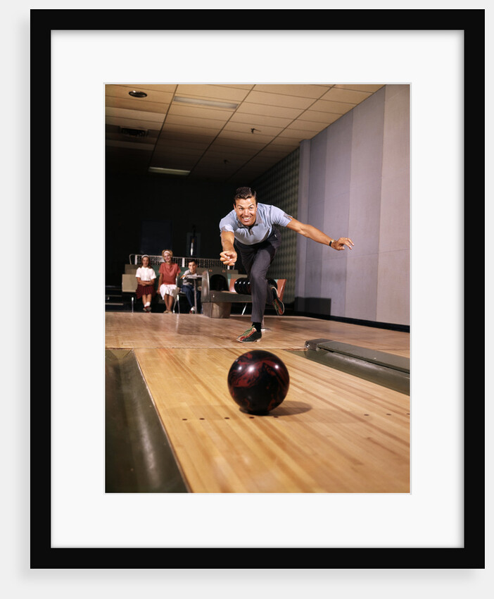 1960s Man In Good Form Releasing Bowling Ball Down Lane Wife Woman 2 Kids Behind Him by Anonymous