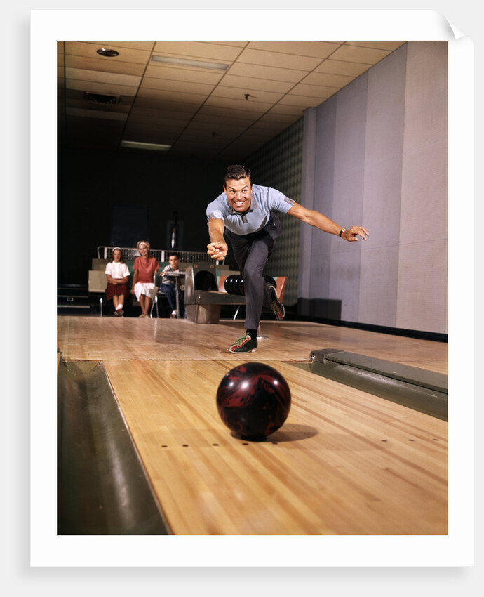 1960s Man In Good Form Releasing Bowling Ball Down Lane Wife Woman 2 Kids Behind Him by Anonymous