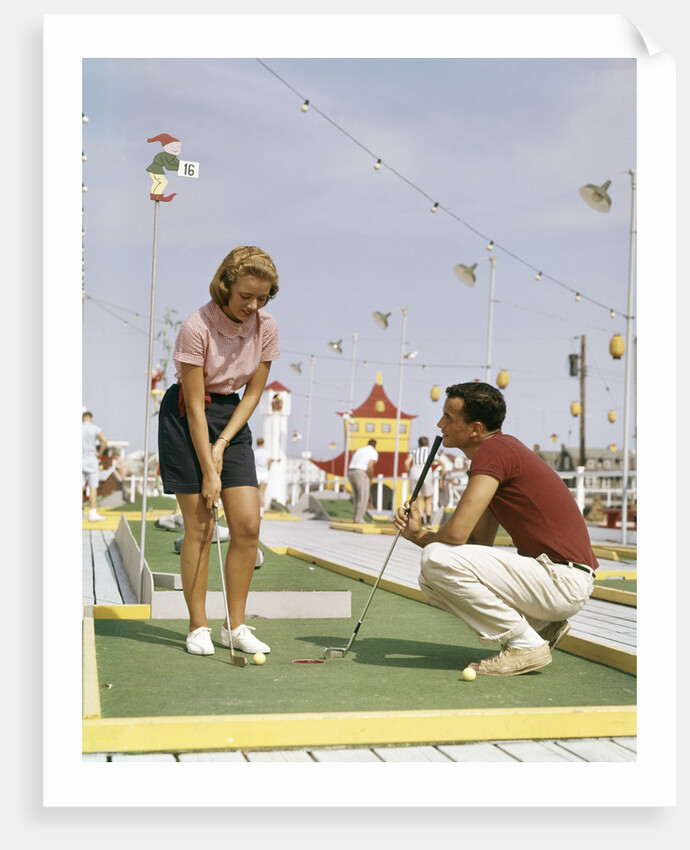 1950s 1960s Young Couple Man Woman Play Miniature Golf Summer Amusement by Anonymous