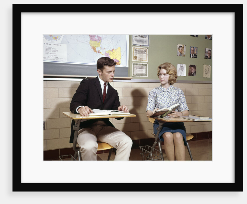 1960s Teenage Boy Girl Seated Classroom Desks Talking by Anonymous
