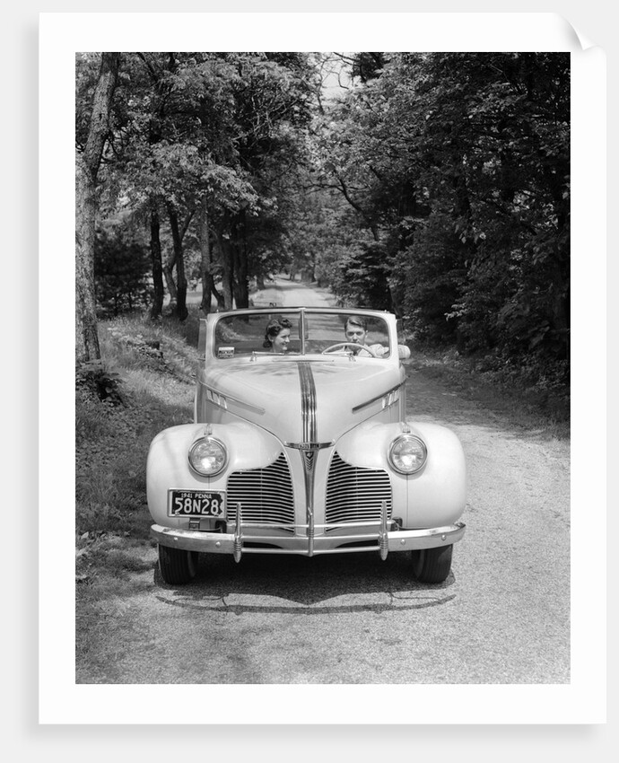 1940s 1941 Couple Man And Woman In Pontiac Convertible Driving On Country Lane In Countryside by Anonymous