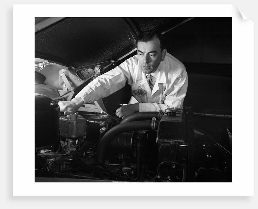1950s Man Automotive Mechanic Servicing Car Engine by Anonymous