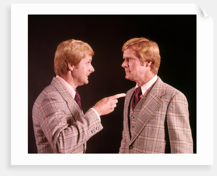 1970s Angry Red Haired Man In Plaid Suit Arguing With Himself by Anonymous