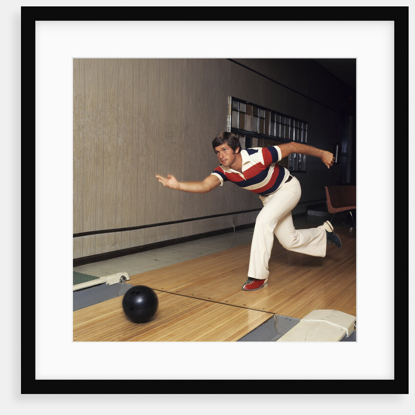 1970s Man Stripe Shirt Flare Leg Pants Throwing Bowling Ball Down Lane Alley by Anonymous