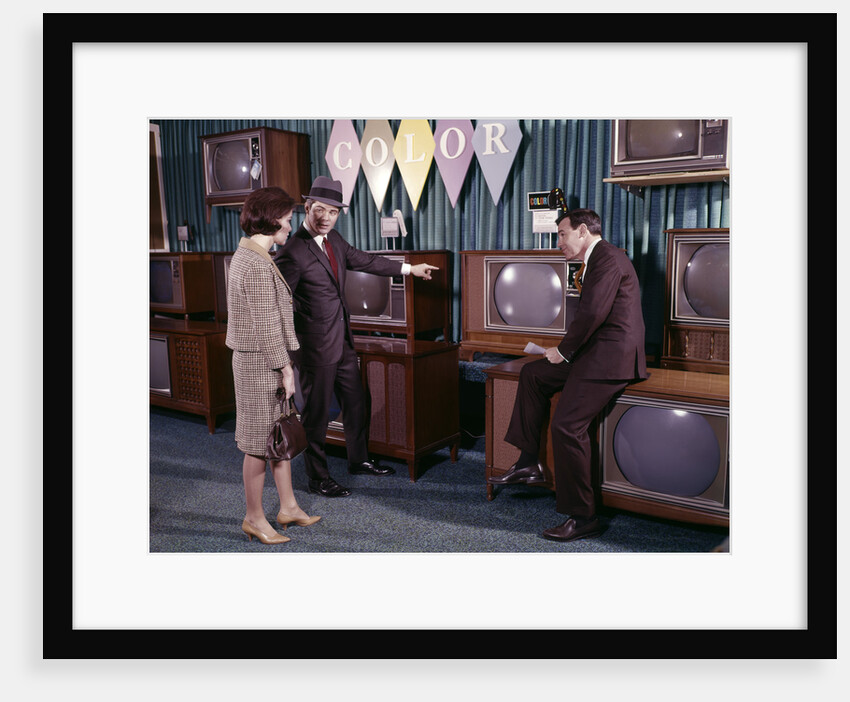 1960s Couple Man Woman Talking To Salesman In Color Television Set Sales Department by Anonymous