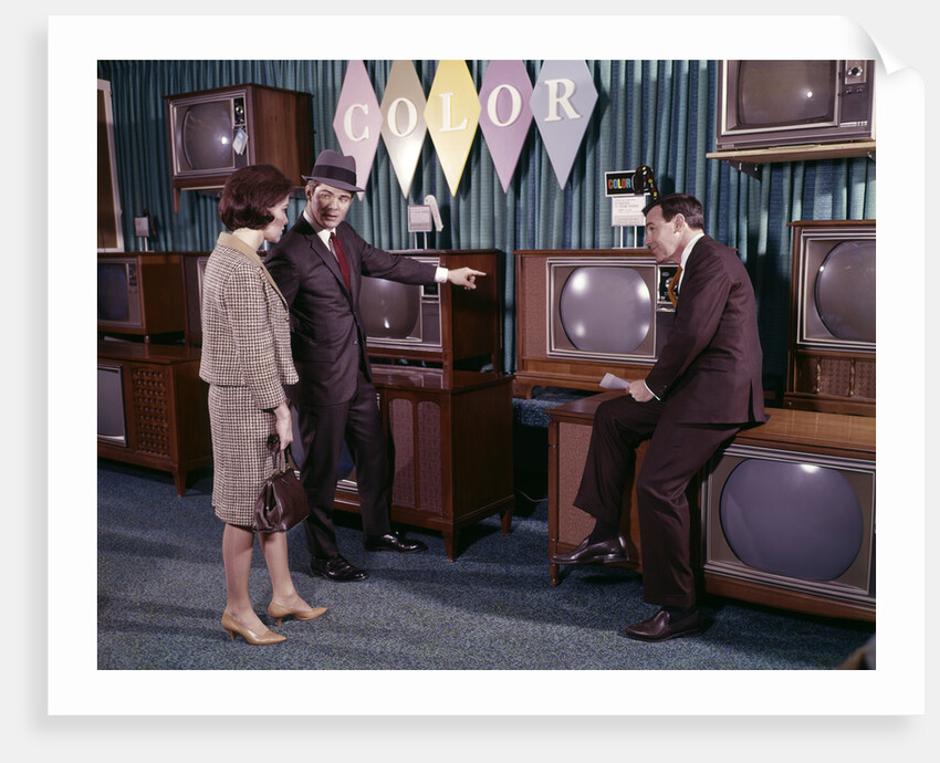 1960s Couple Man Woman Talking To Salesman In Color Television Set Sales Department by Anonymous