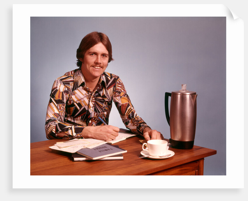 1970s Young Man Mustache Loud Print Shirt Desk Empty Coffee Cup Pot Family Budget by Anonymous