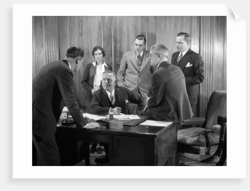 1930s Worried Business Group In Office Meeting Around The Boss' Desk by Anonymous