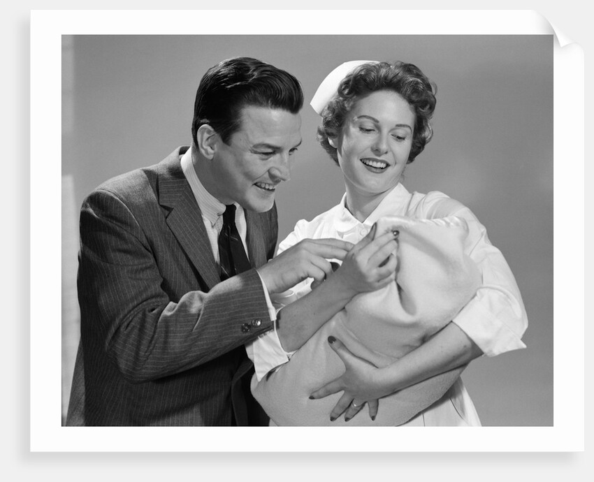 1950s 1960s Man New Father Looking At Baby Held By Woman Nurse by Anonymous