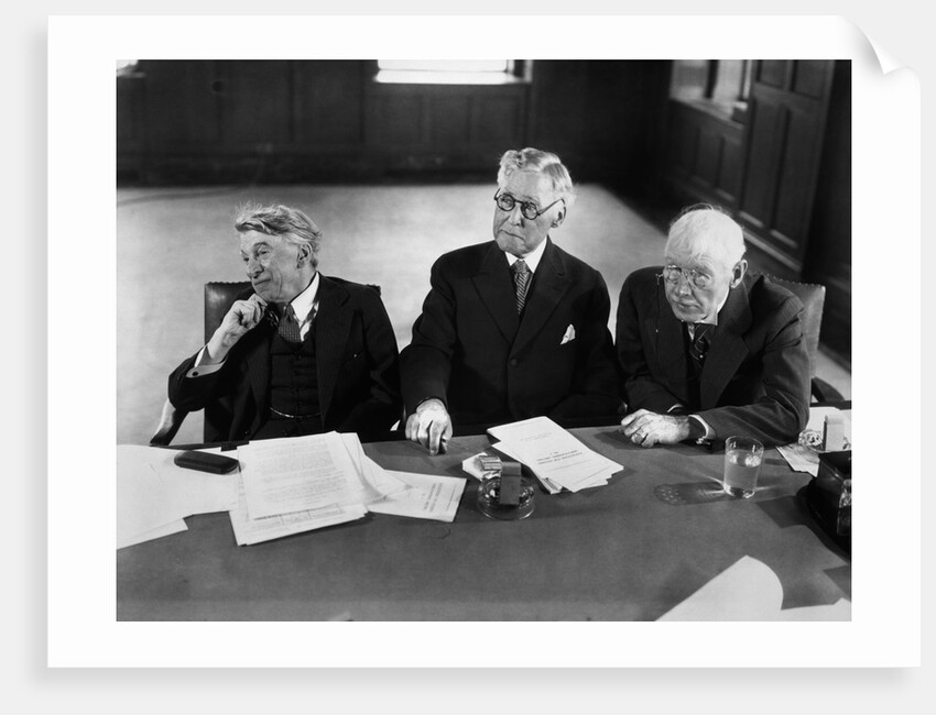 1930s 1940s Elderly Businessmen Sitting At Conference Table With Attention Directed To Speaker Not Shown by Anonymous