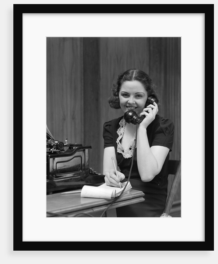 1930s Woman Receptionist Secretary Sitting At Desk In Office Talking On Telephone by Anonymous