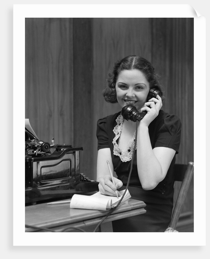 1930s Woman Receptionist Secretary Sitting At Desk In Office Talking On Telephone by Anonymous