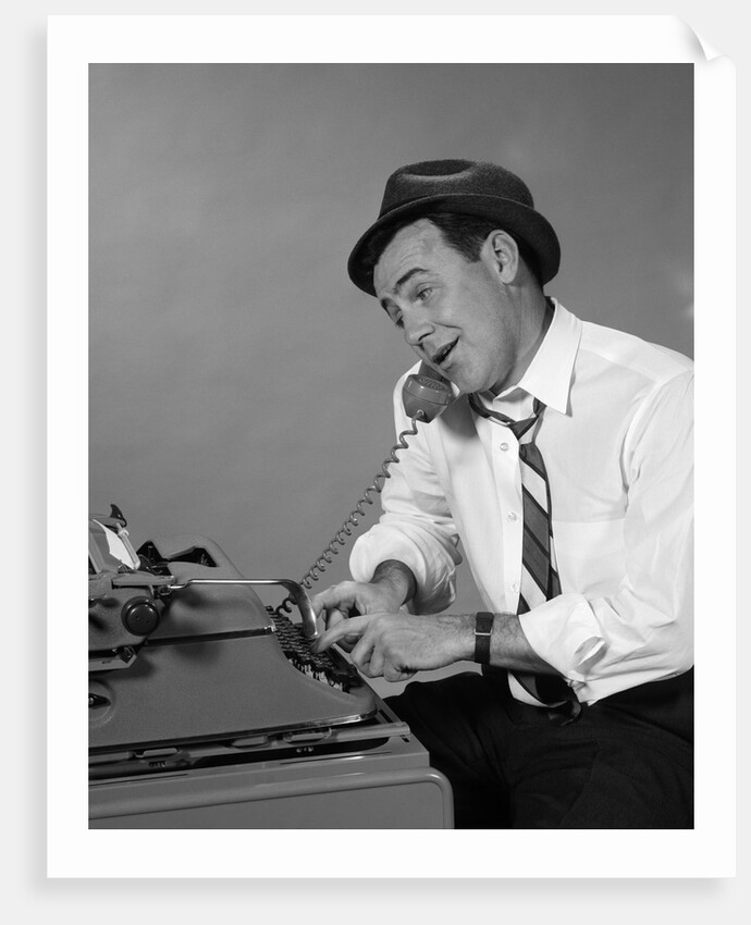 1960s Reporter With Hat On Phone At Typewriter by Anonymous