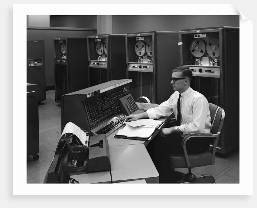 1960s Man In Shirt Tie and Thick Black Glasses Working With IBM Data Processing System by Anonymous
