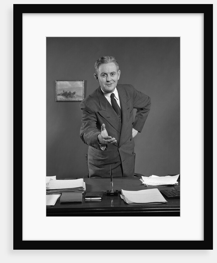 1950s Man Businessman Salesman Reaching Across Desk To Shake Hands by Anonymous