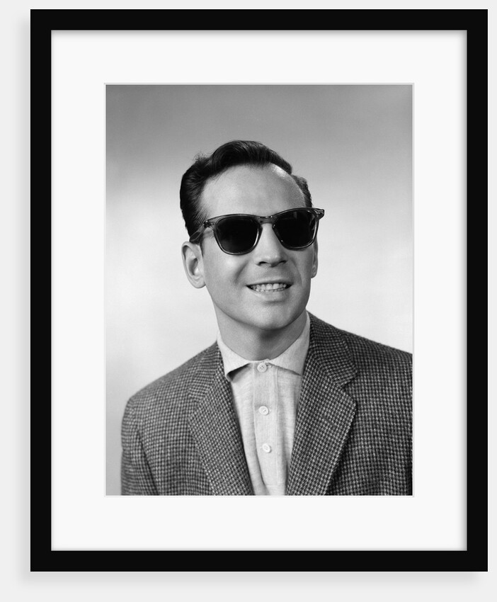 1950s 1960s Portrait Of Blind Man Wearing Sports Jacket Shirt And Very Dark Protective Sunglasses by Anonymous