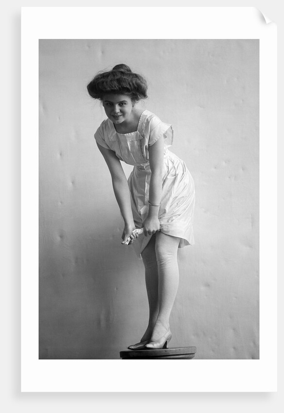 1900s 1910s Woman With Gibson Girl Hair Style Ringing Out Wet Chemise Hemline by Anonymous